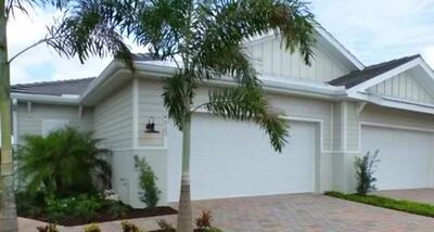 a front view of house with green space