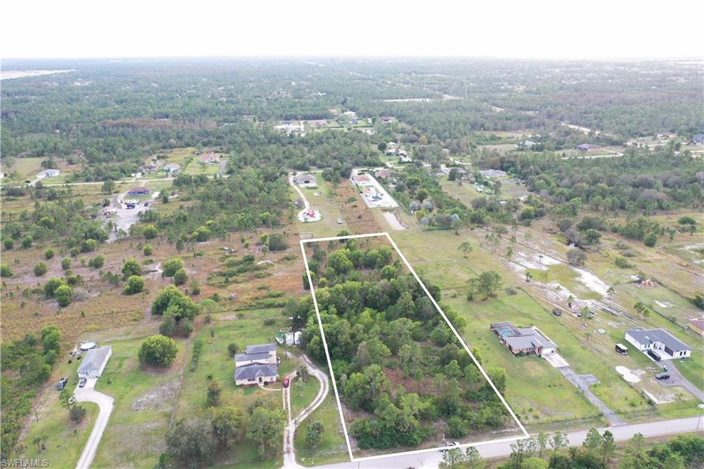 an aerial view of house with yard