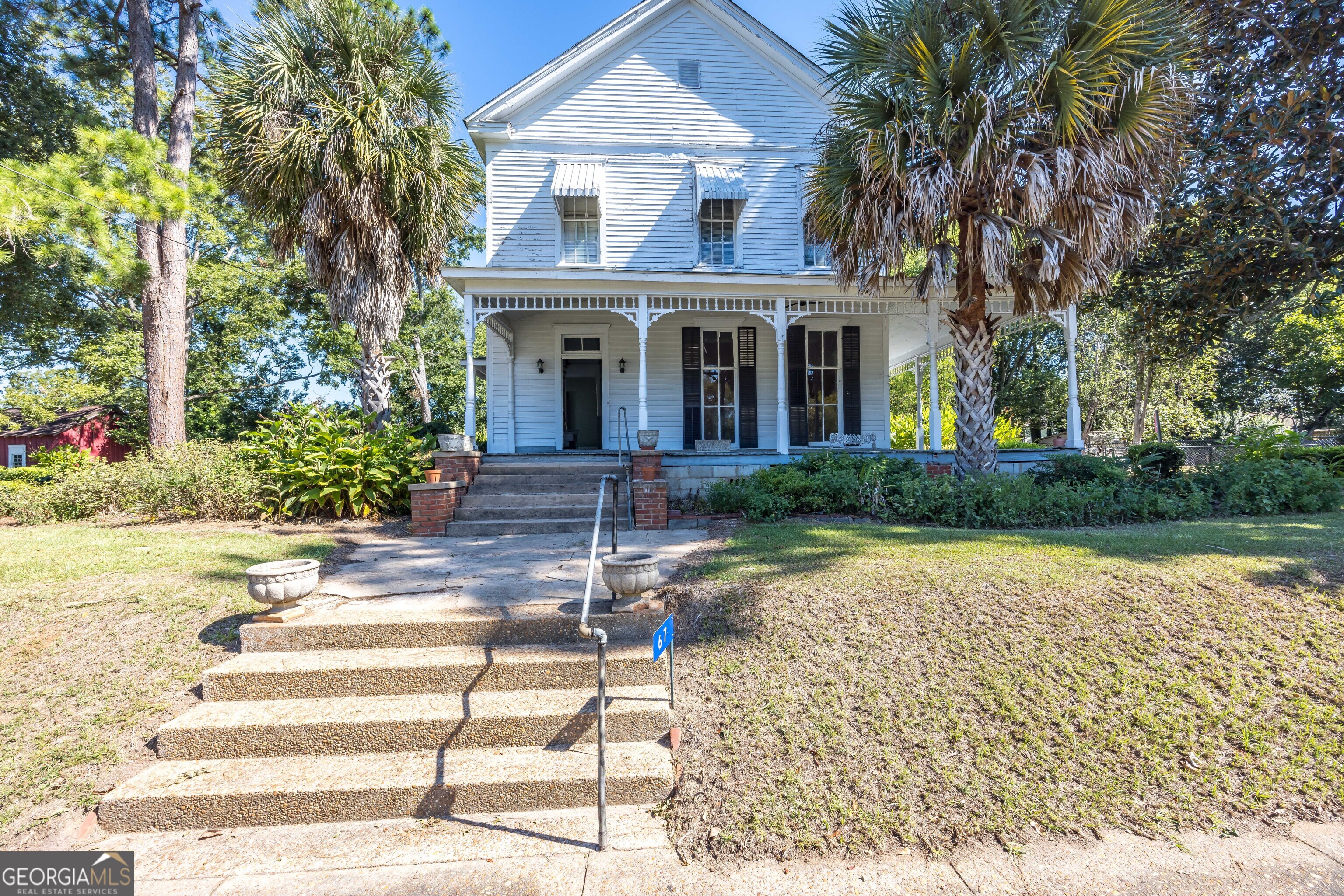 a front view of a house with garden