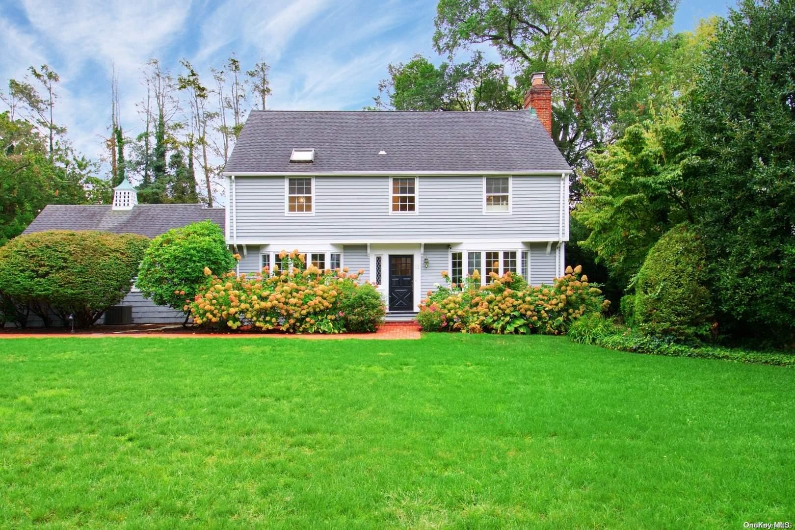 a aerial view of a house next to a yard