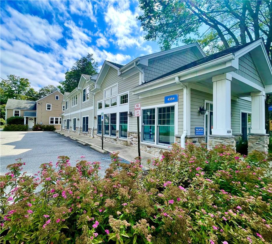 View of front/side of commercial and residential properties with covered porch