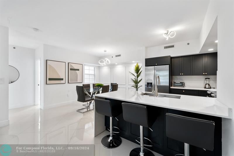 a kitchen with stainless steel appliances kitchen island granite countertop a sink and cabinets