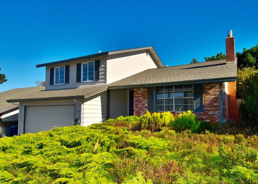 a front view of a house with garden