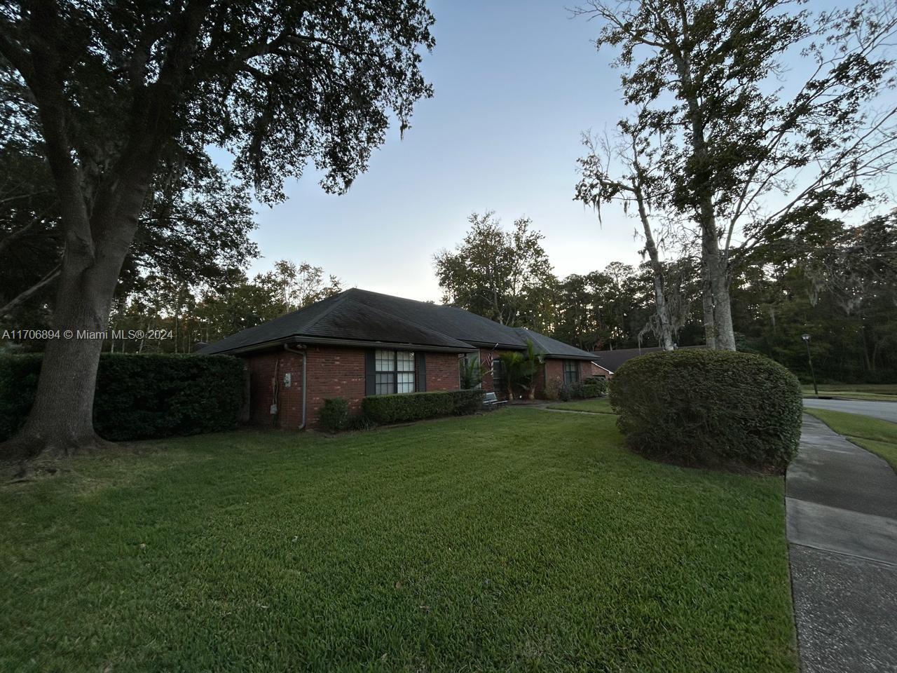 a view of a house with a yard and a garden