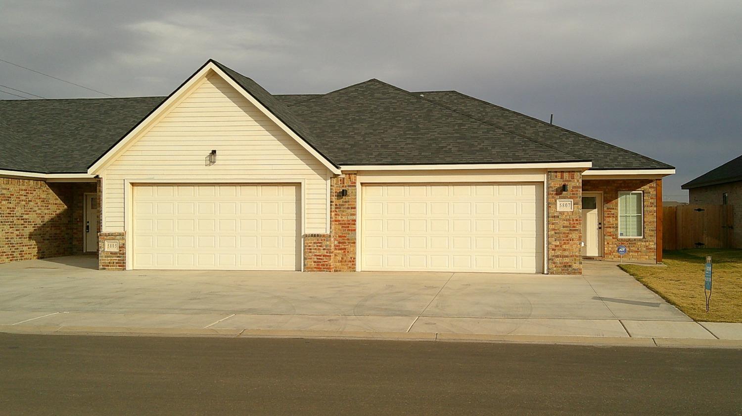 a view of an house with backyard and road