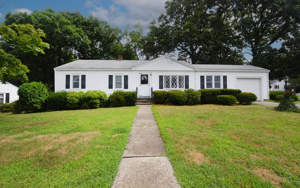 a front view of house with yard and green space