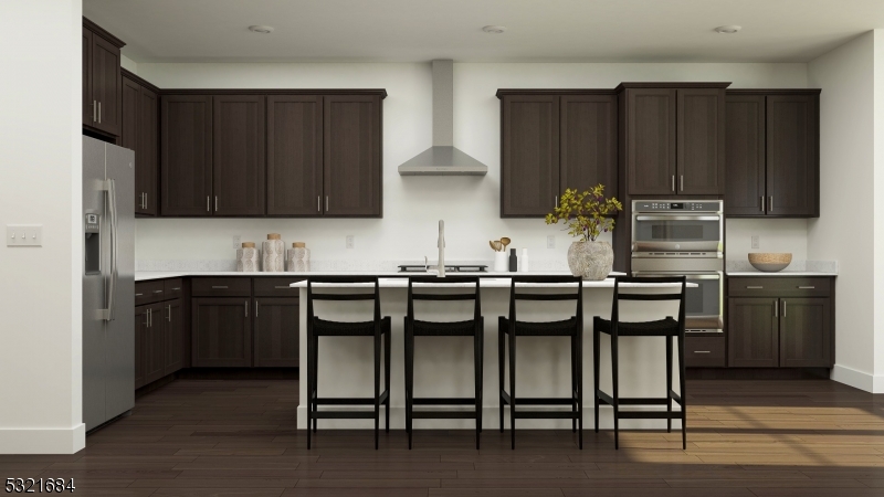 a kitchen with granite countertop a stove top oven microwave and cabinets