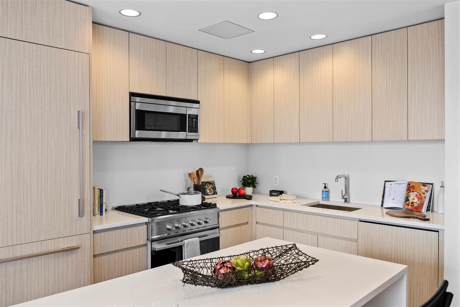 a kitchen with a sink a microwave and cabinets