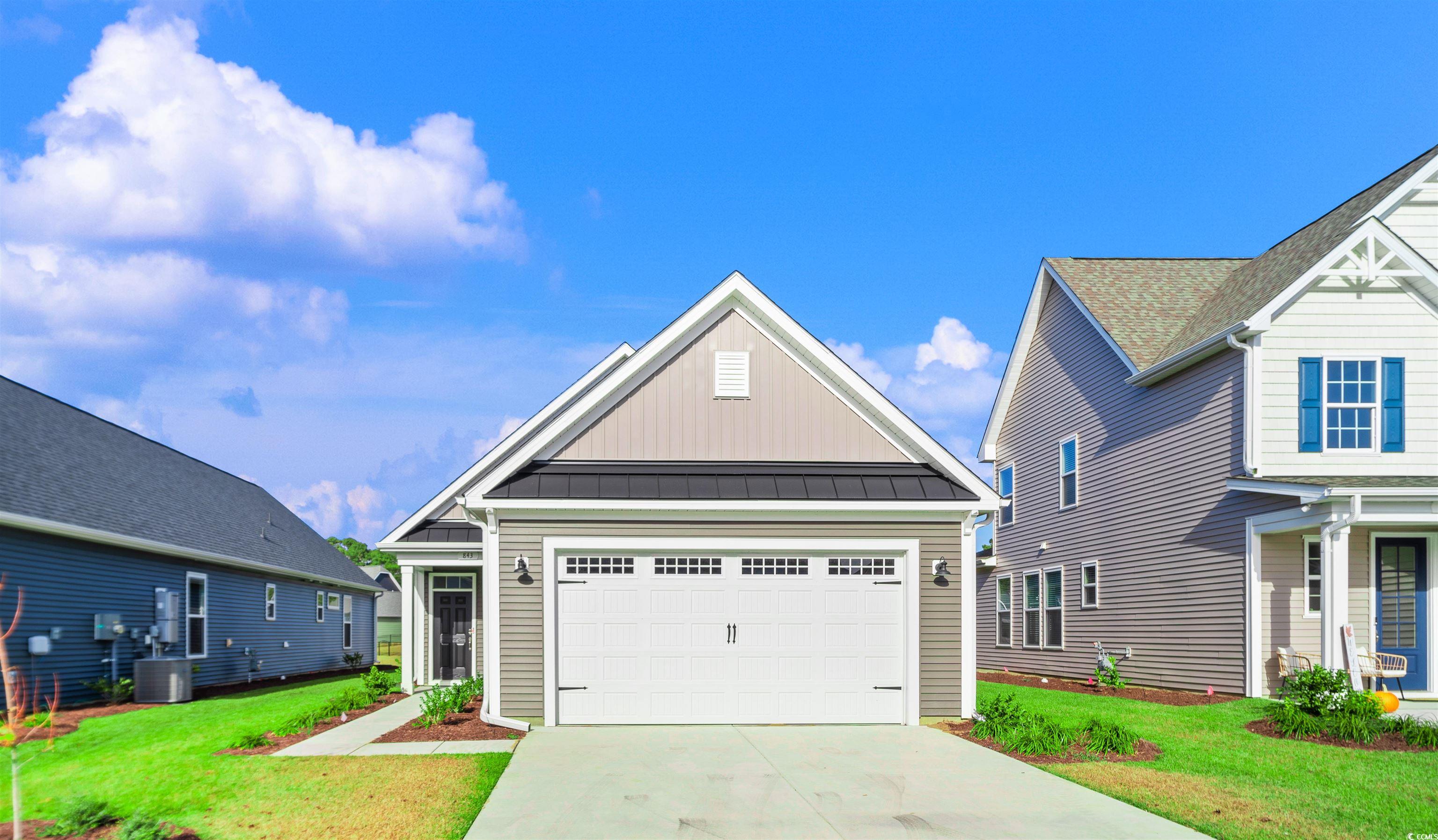 View of front of house with a front lawn, a garage