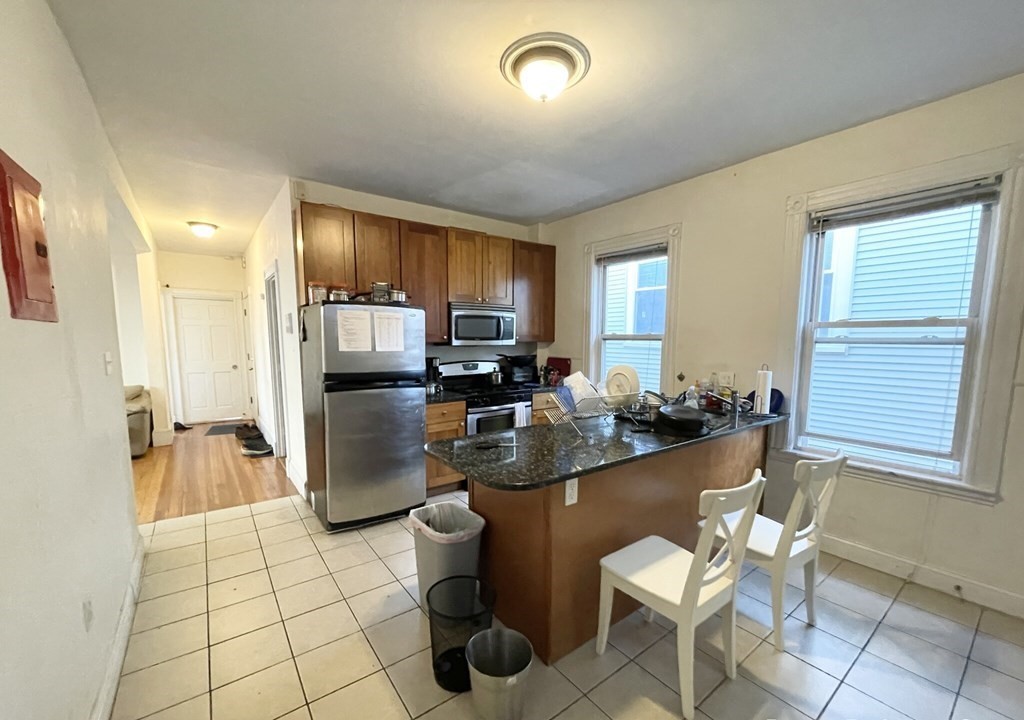 a kitchen with a sink and a refrigerator