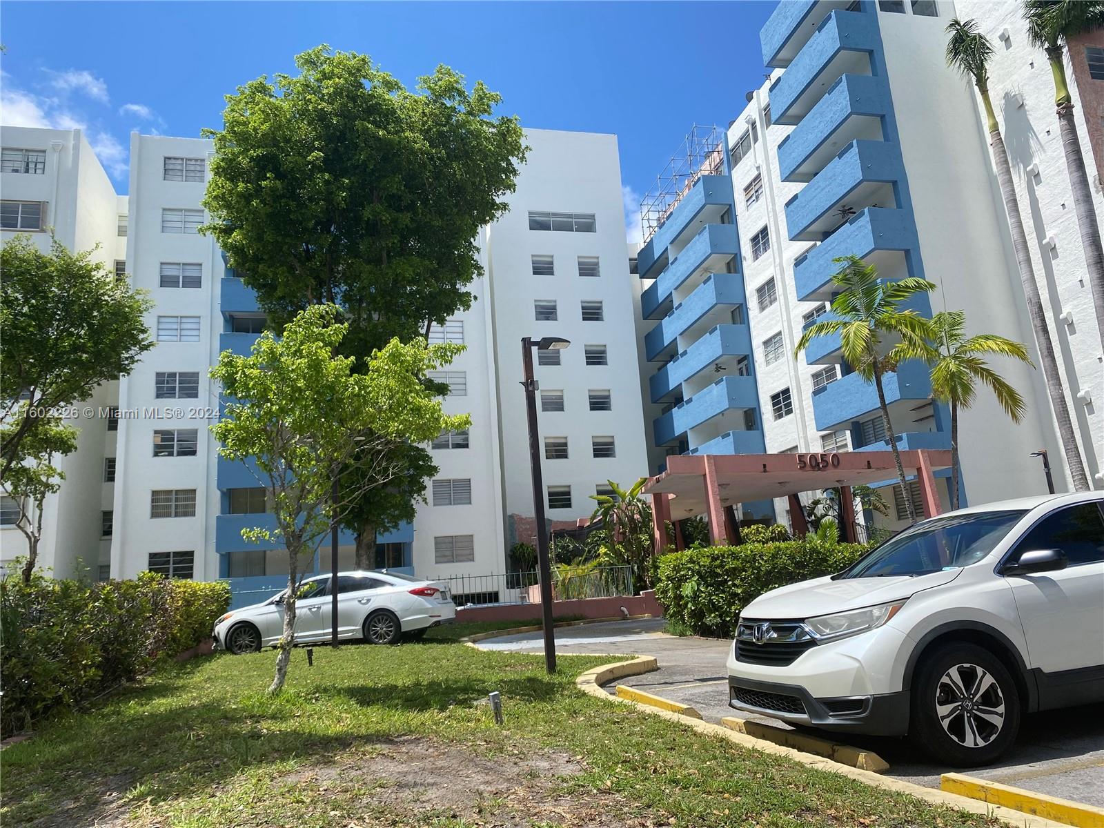 a front view of a residential apartment building with a yard