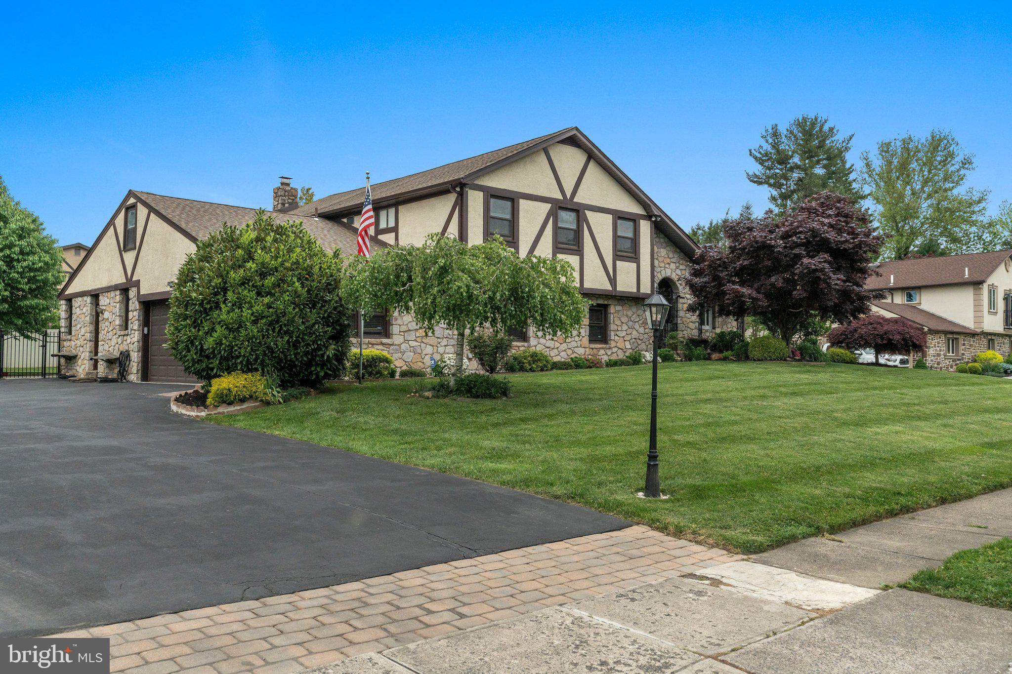 a front view of a house with a yard and trees