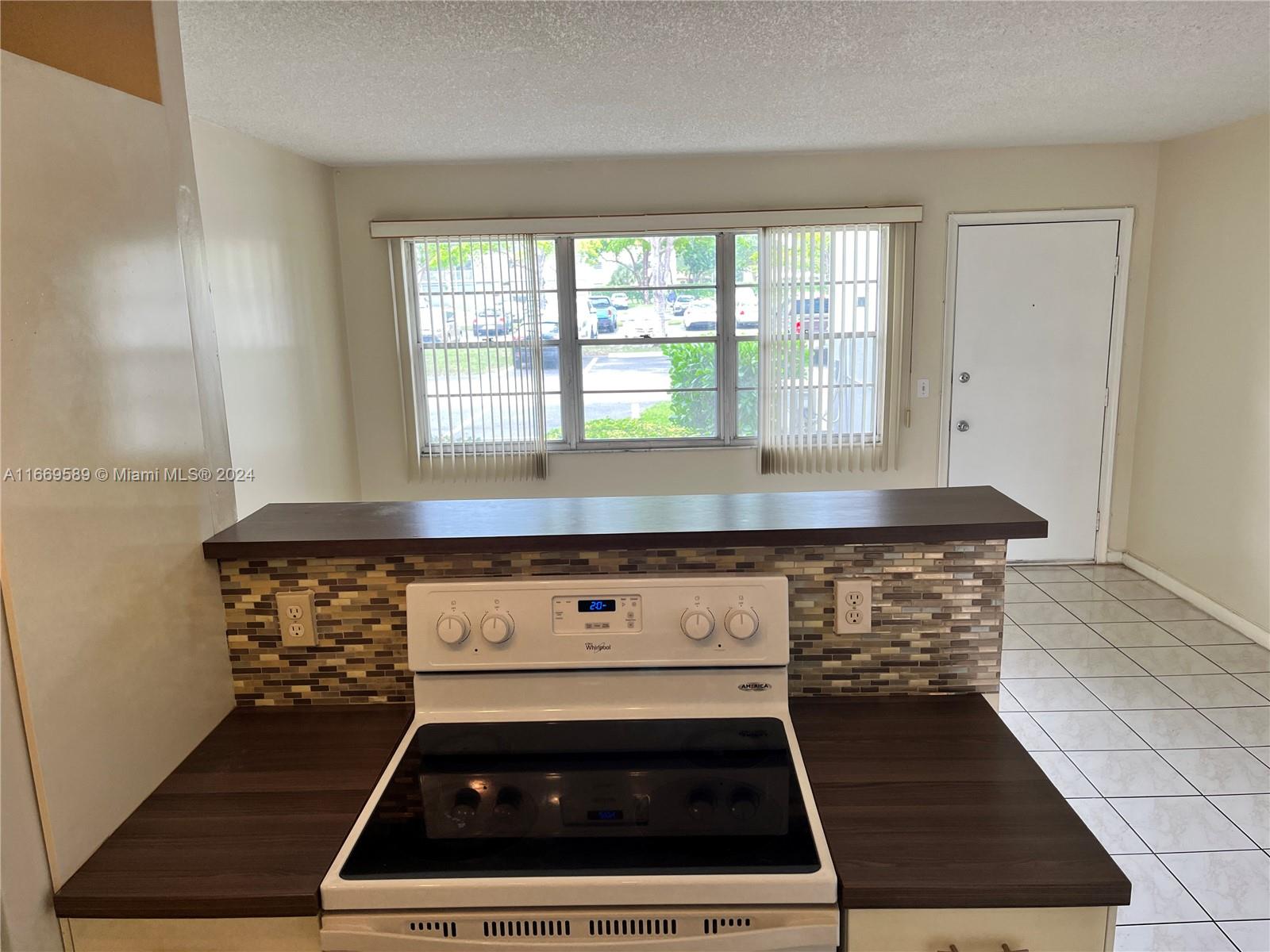 a stove top oven sitting inside of a kitchen