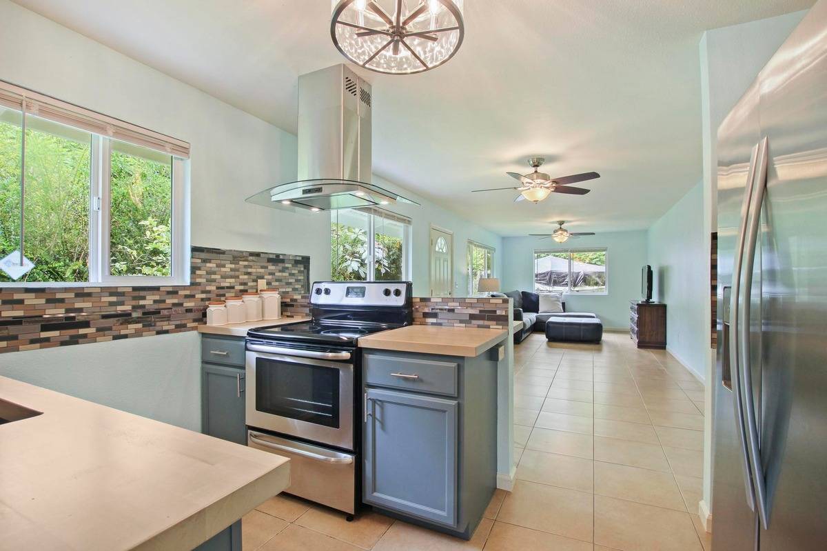 a kitchen with a stove a refrigerator and a fireplace