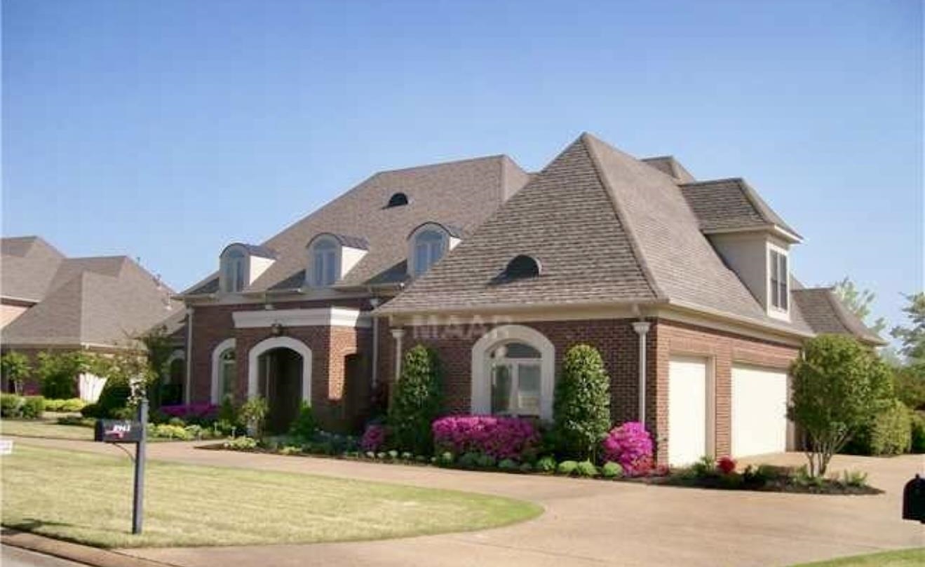 Exterior space with a front lawn and a garage