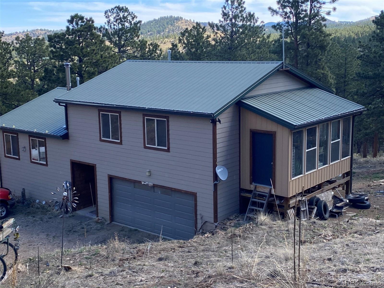 a aerial view of a house with a yard and trees