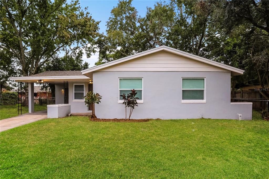 a front view of house with yard and green space