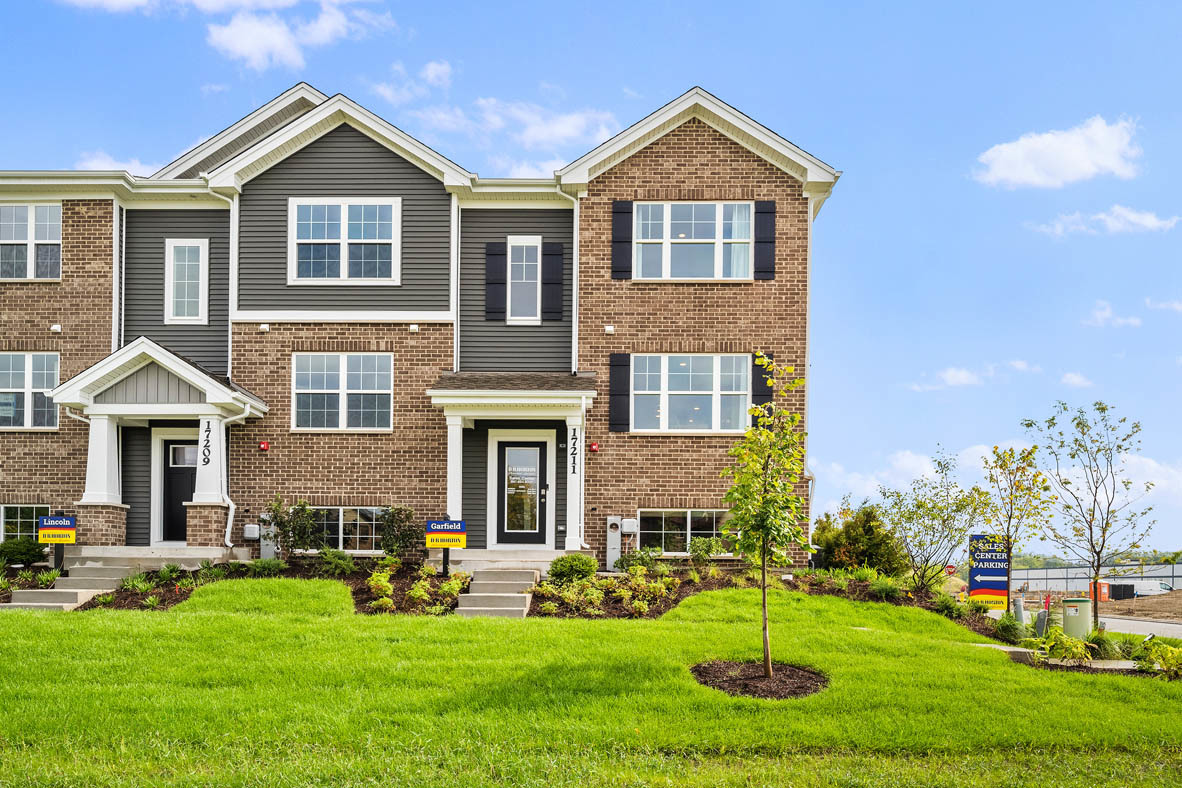 a front view of a house with a yard and garage