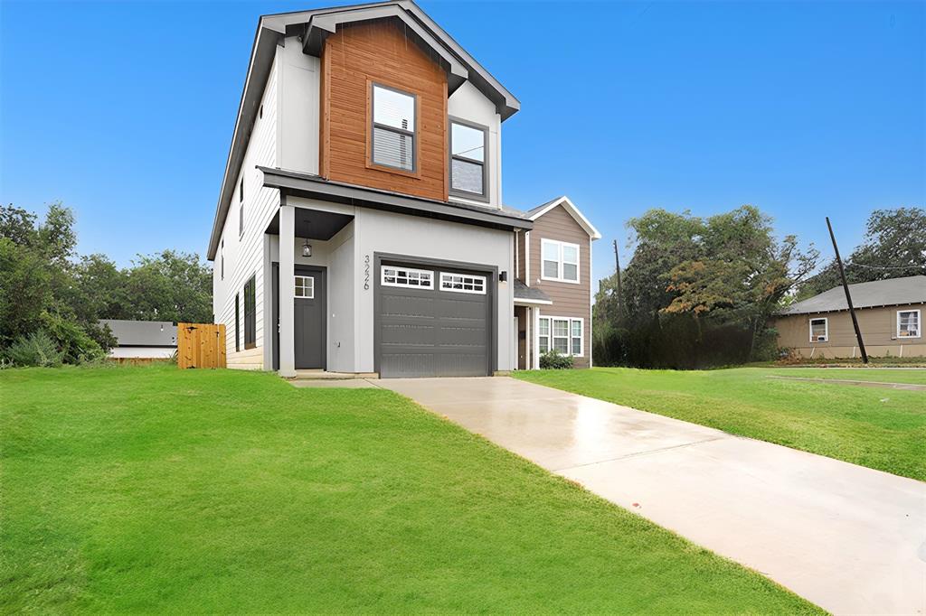 a front view of a house with a yard and garage