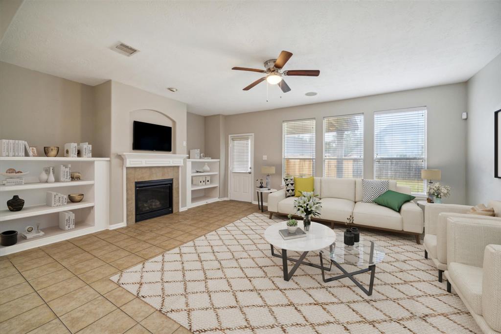 a living room with furniture fireplace and window