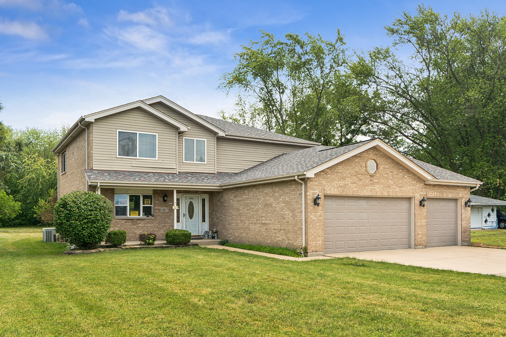 a front view of a house with a garden and yard