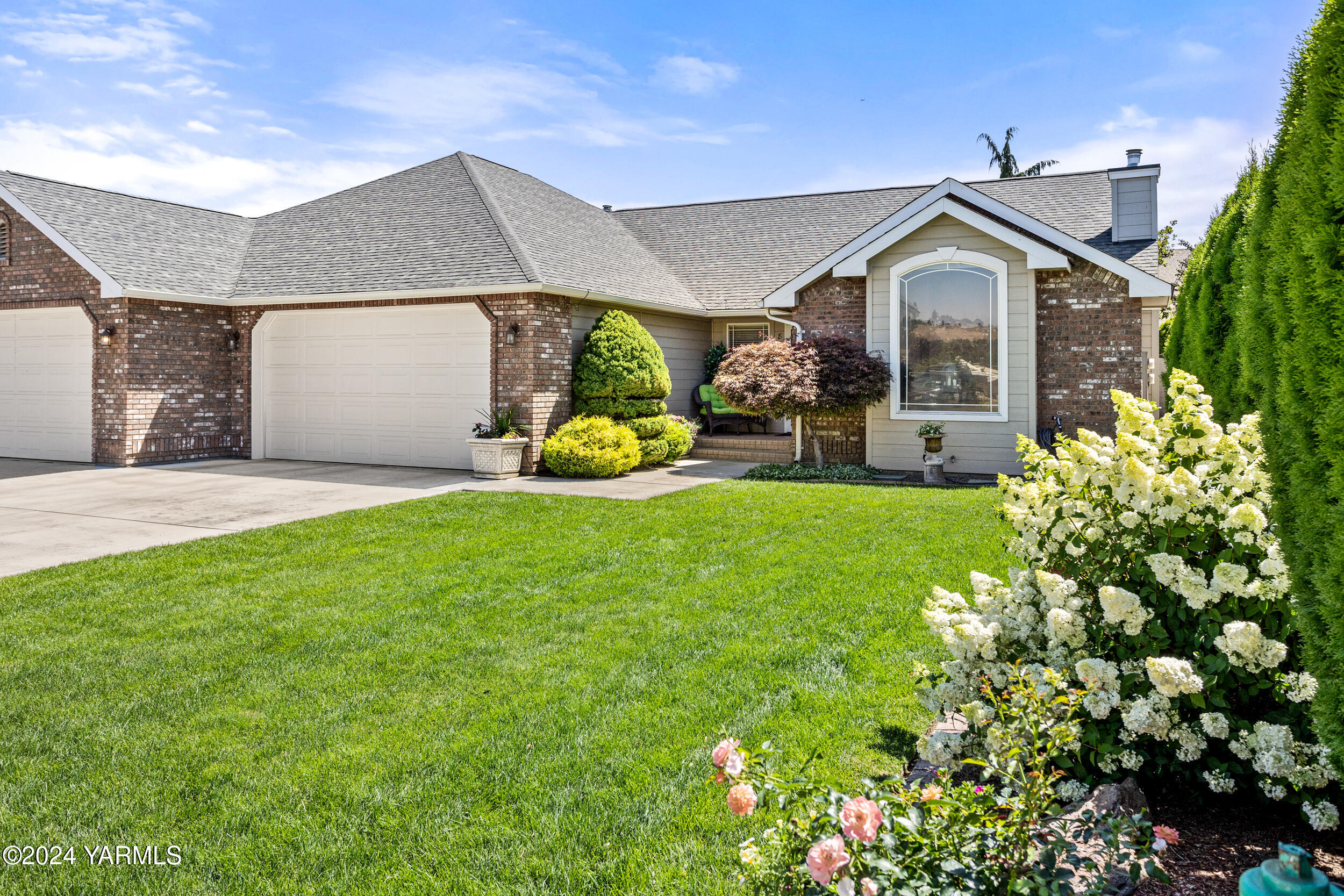 a front view of a house with garden