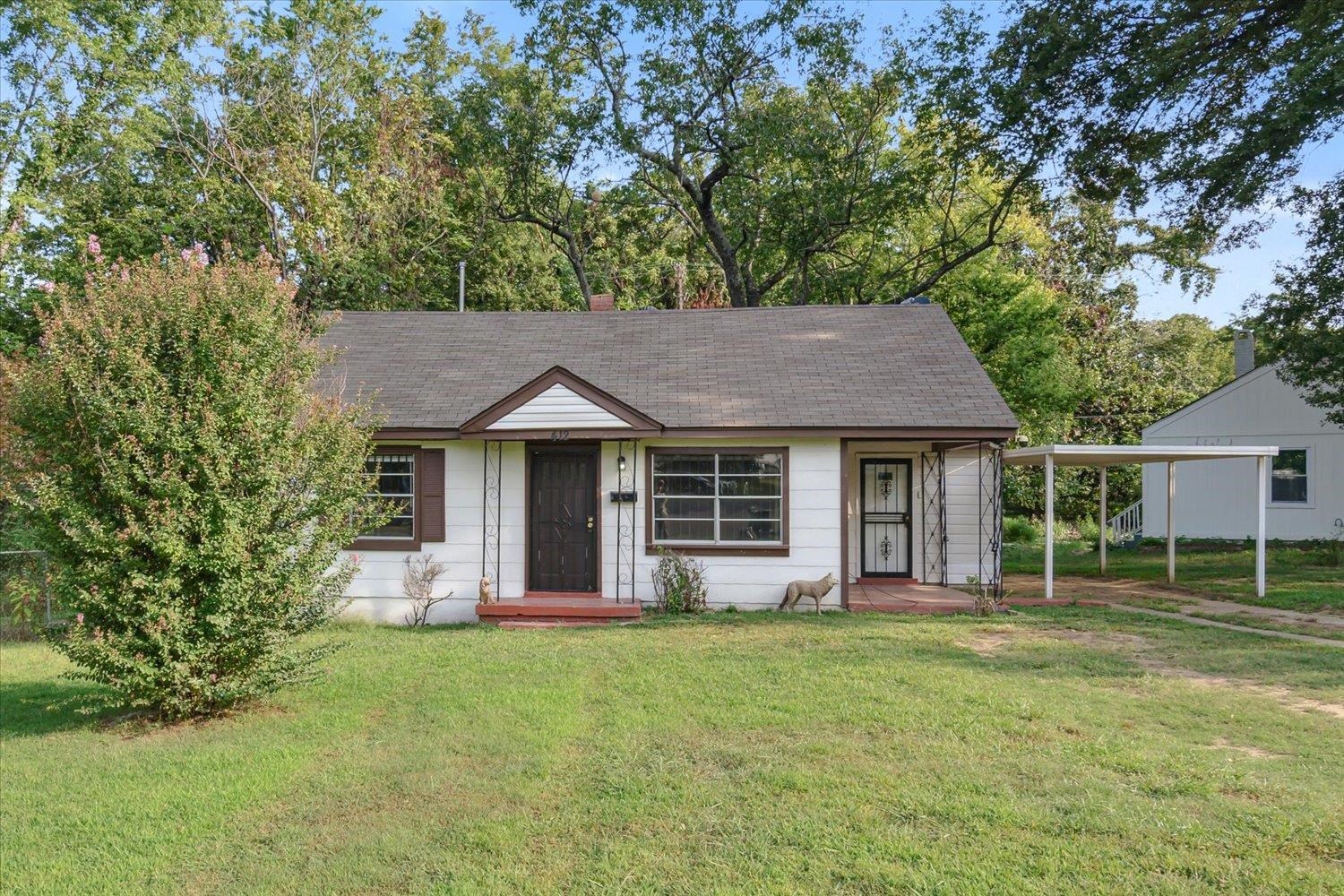 front view of a house with a yard