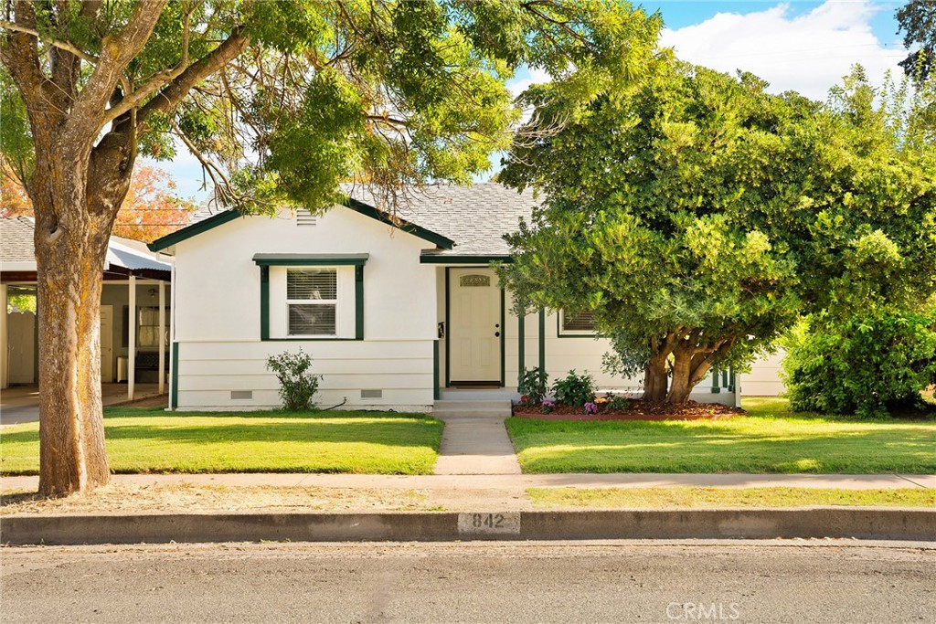 a house that has a tree in front of it