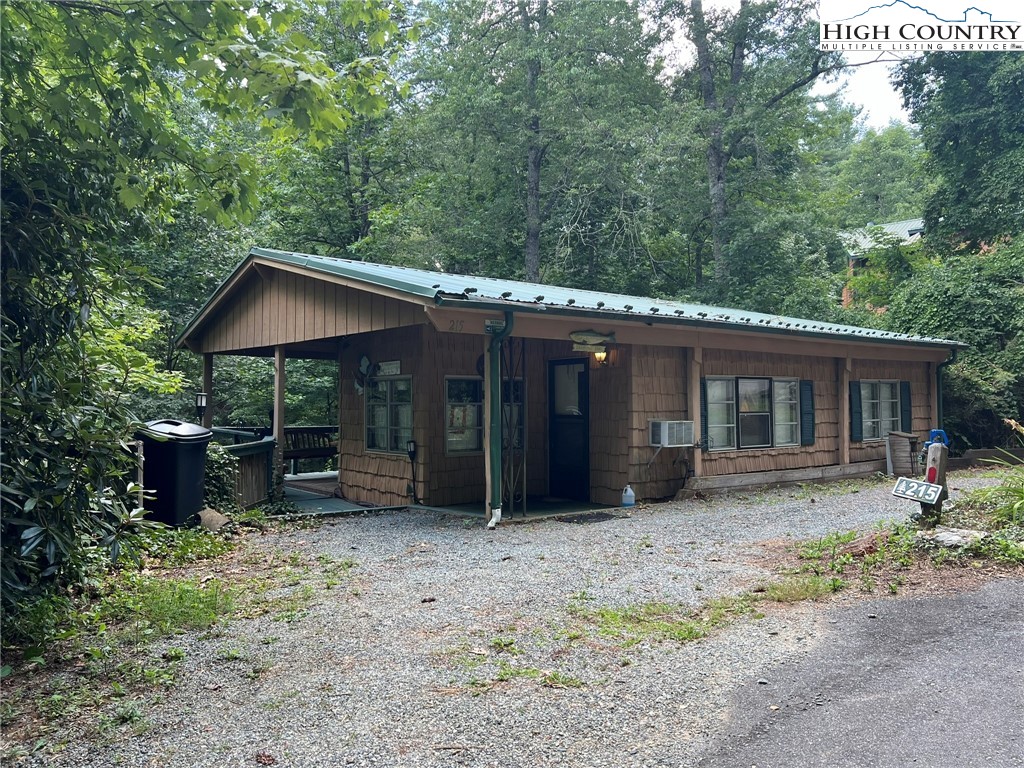 a view of a house with a yard and sitting area