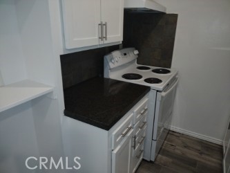 a kitchen with a stove and a refrigerator