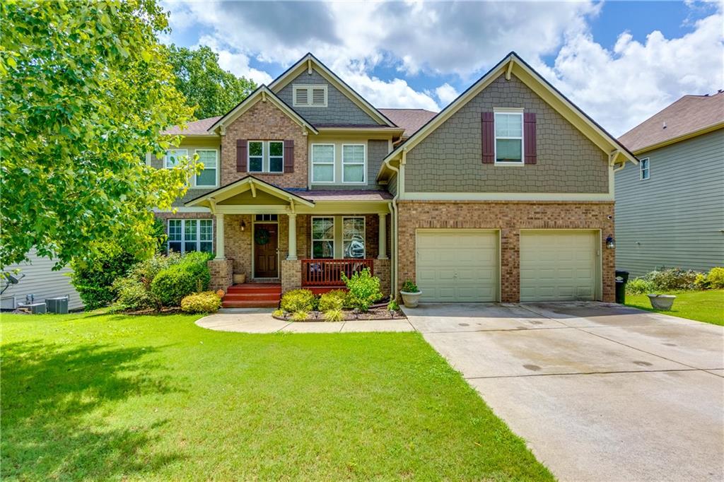 a front view of a house with a yard and porch