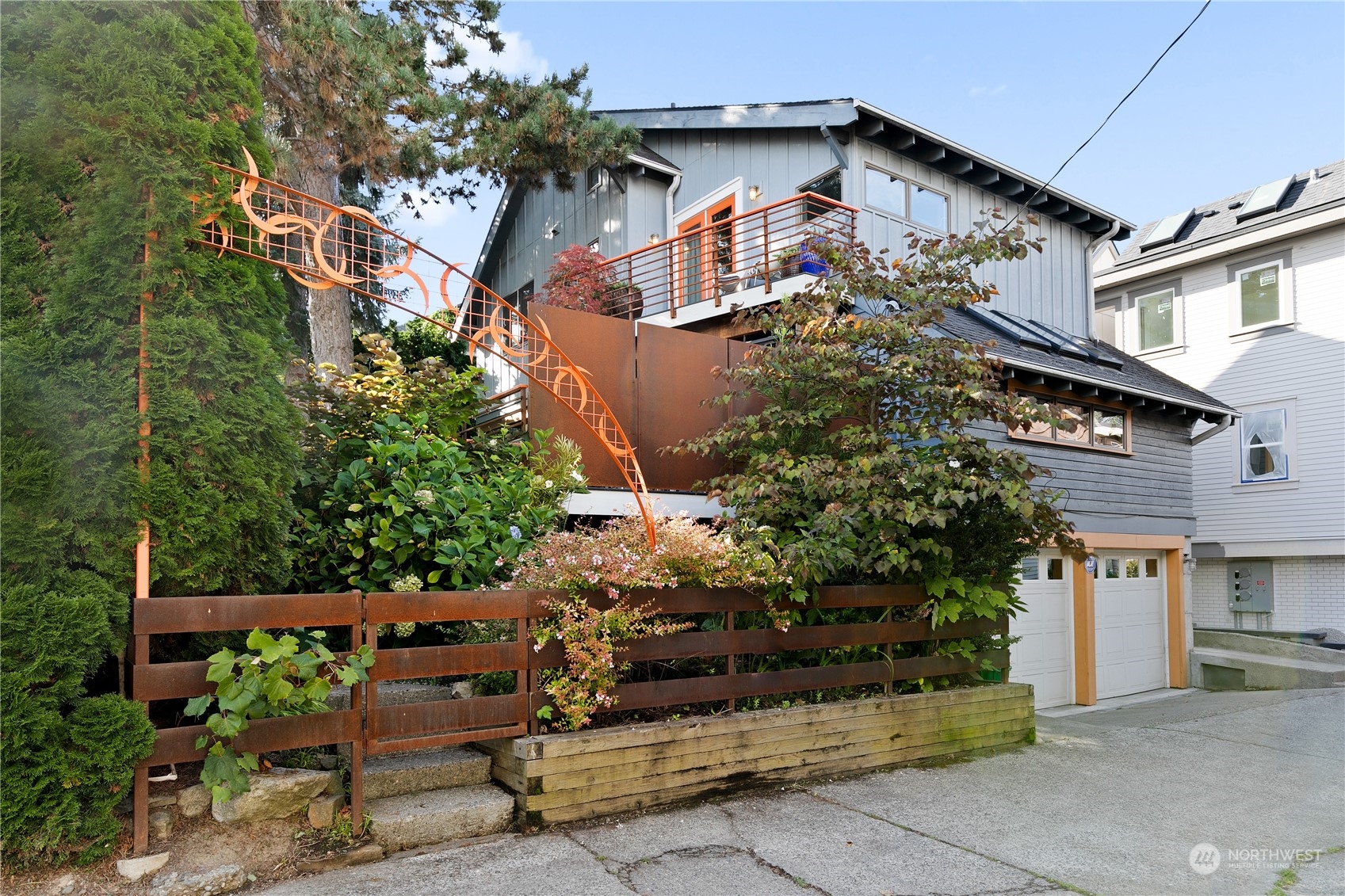 a front view of a house with a garden