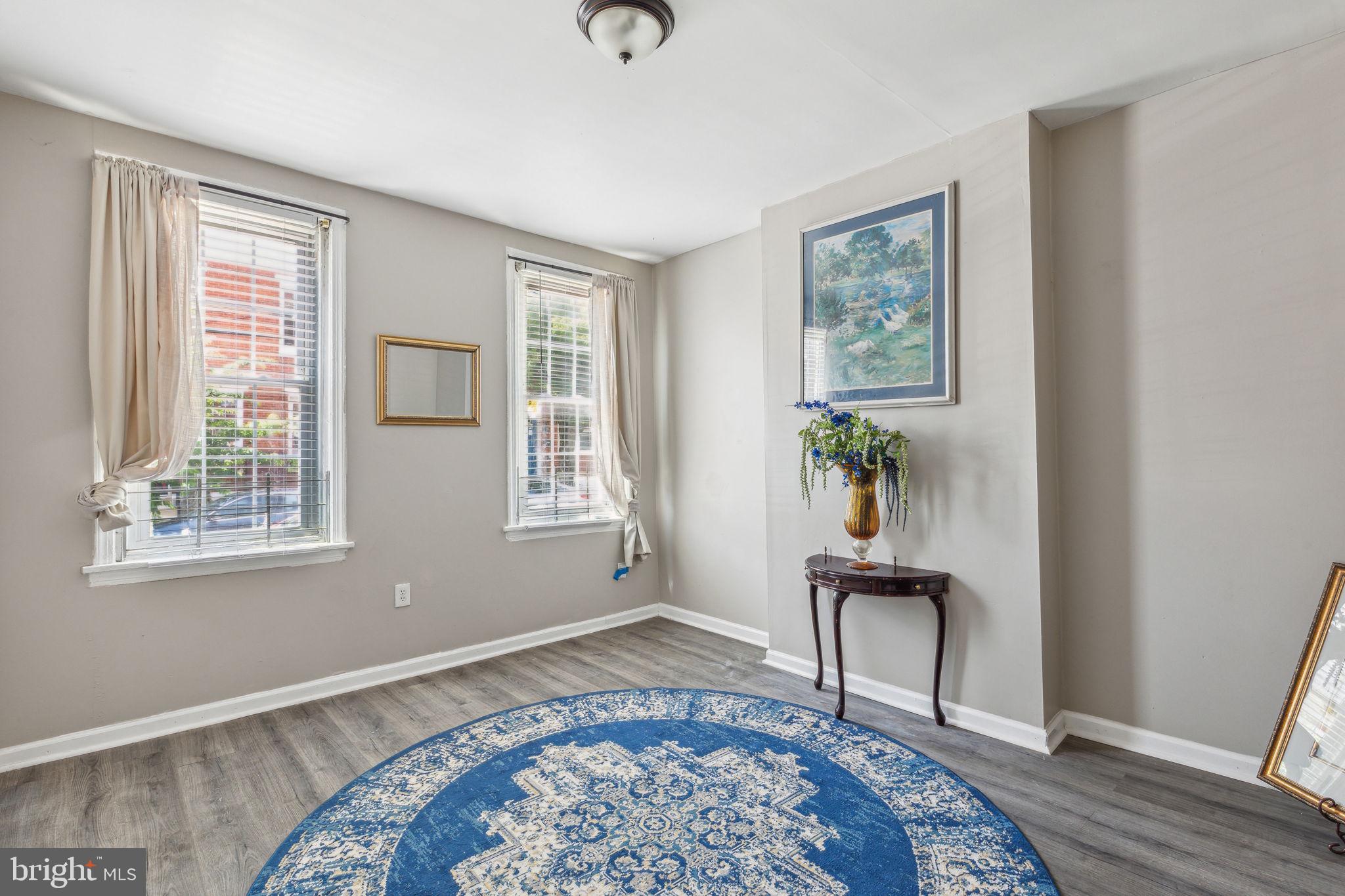 a view of a livingroom with wooden floor and a window