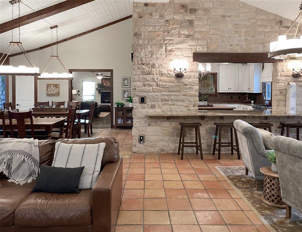 a living room with patio furniture and a fireplace