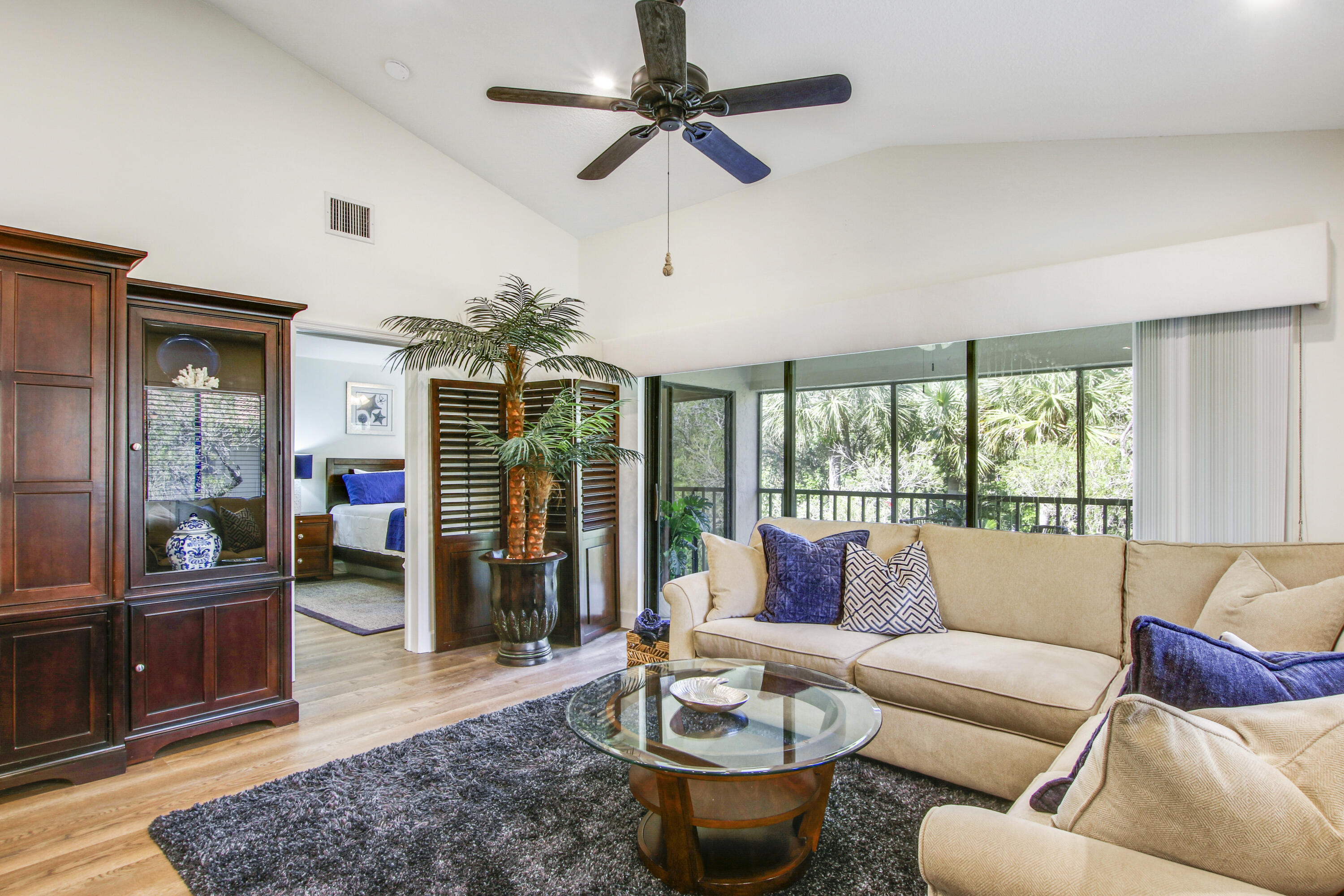 a living room with furniture a chandelier and a large window