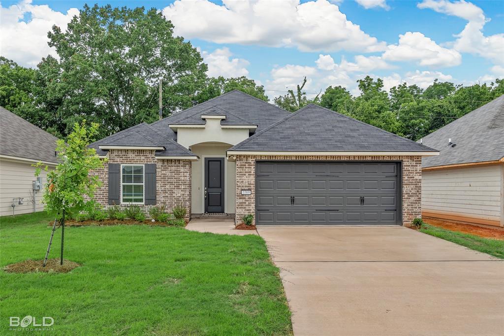 a front view of a house with a yard and garage