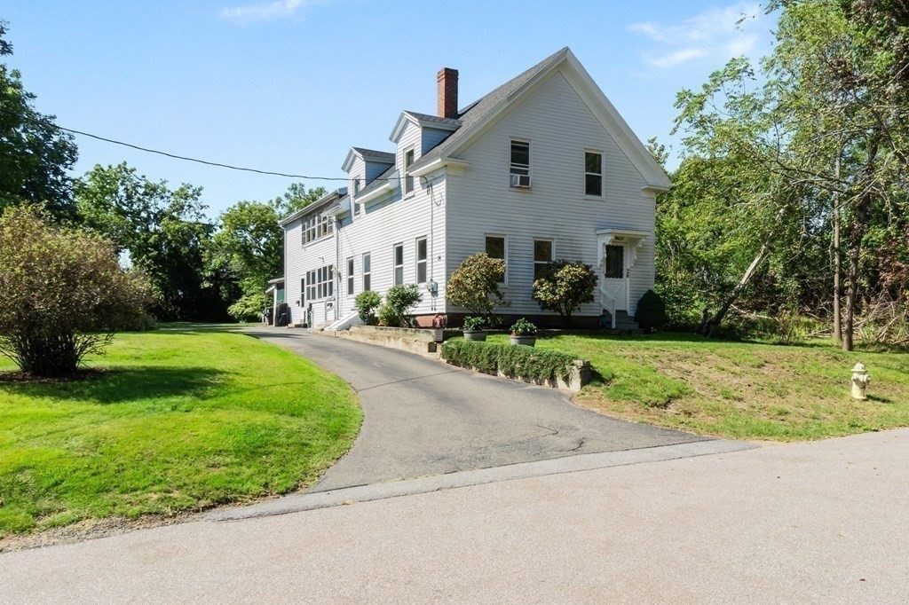 a front view of house with yard and green space