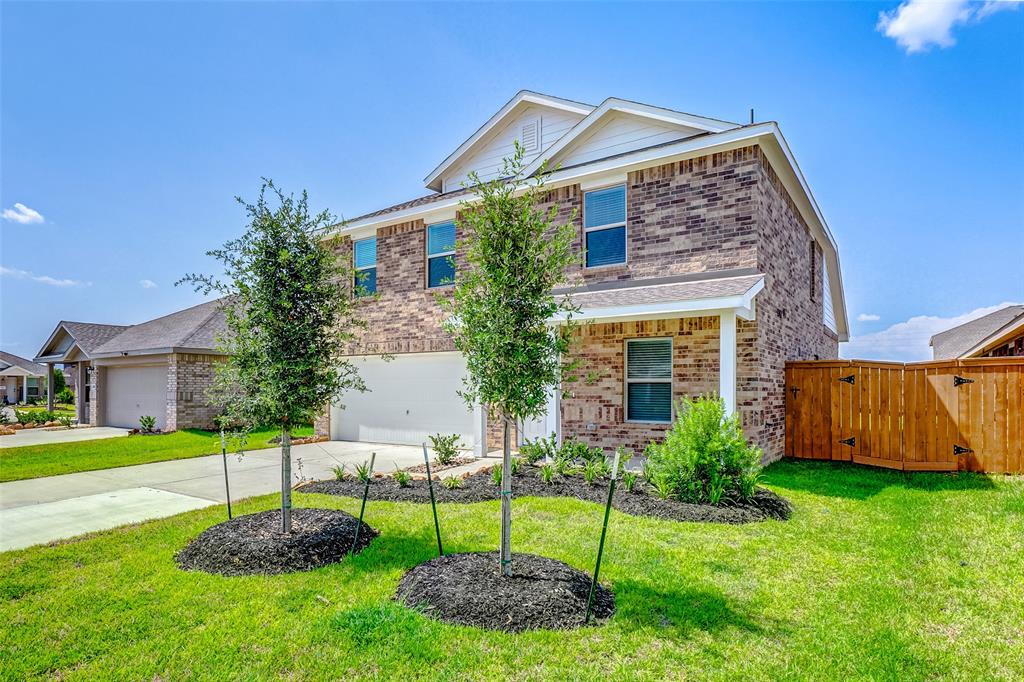 a view of a house with a yard and a garden