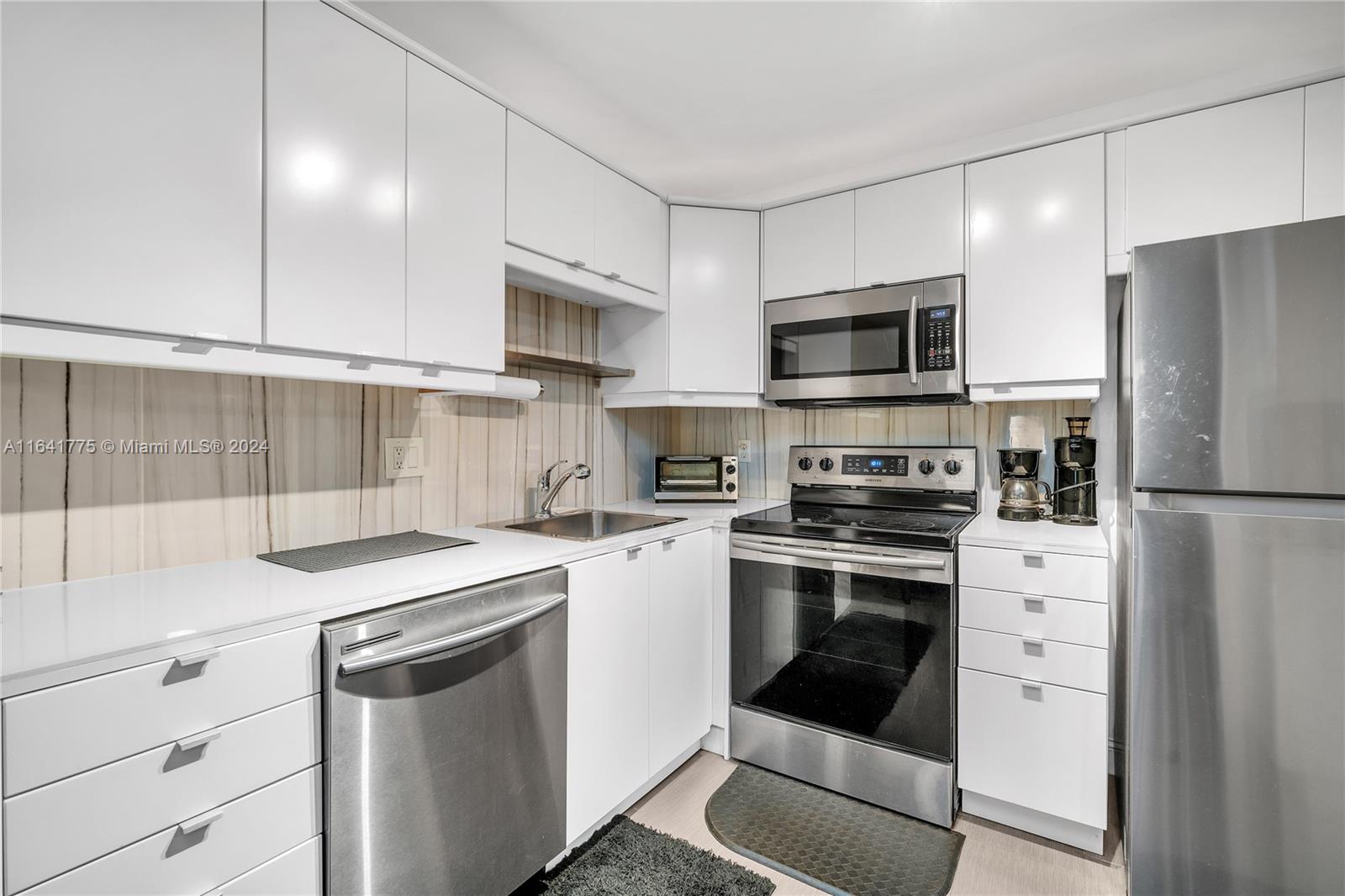 a kitchen with a sink stove and refrigerator