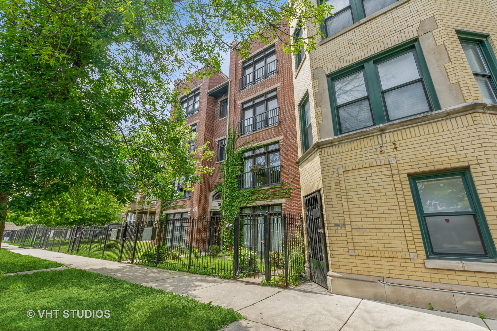 a view of a brick building next to a yard