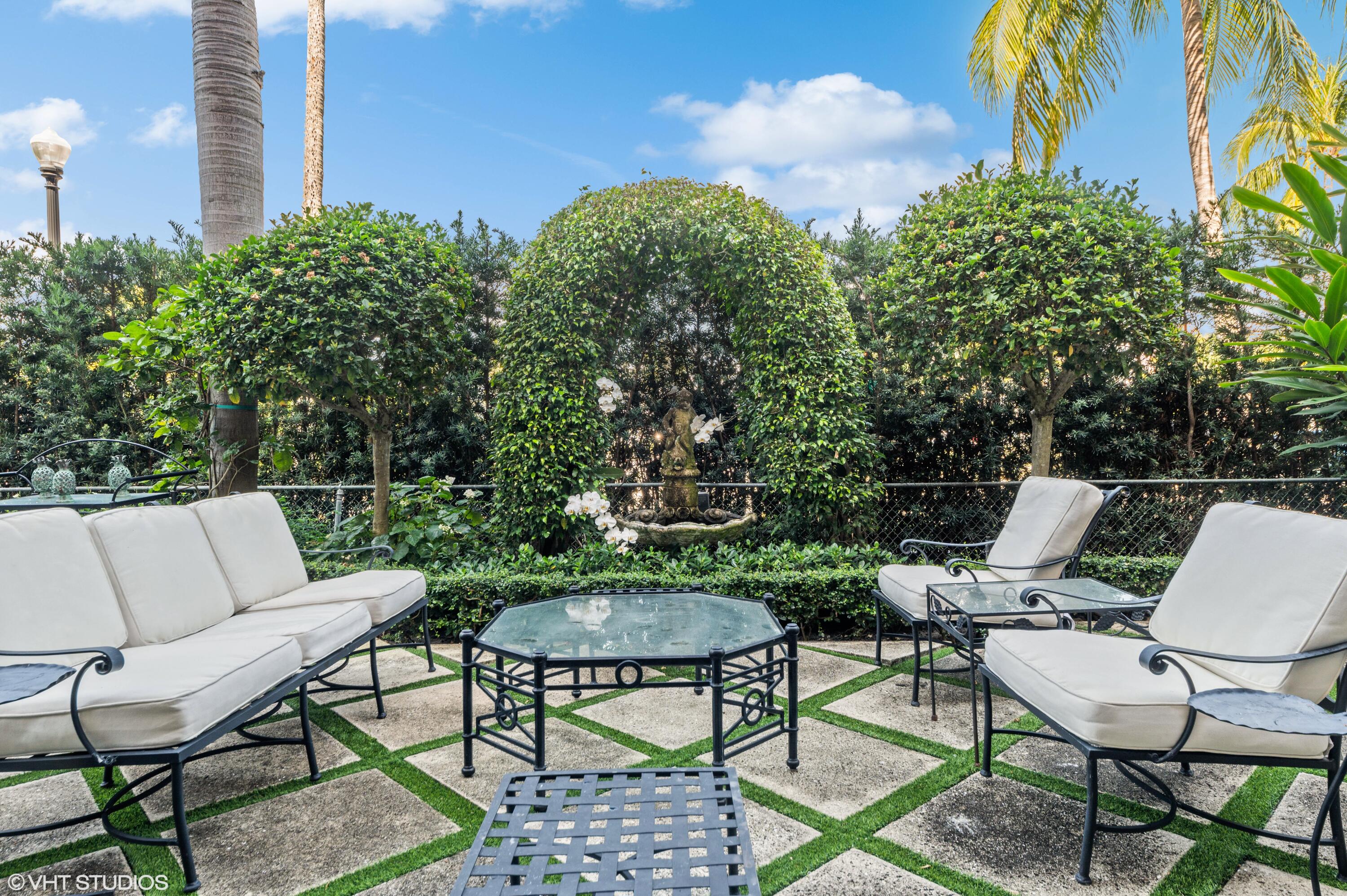 a view of a chairs and table in a backyard