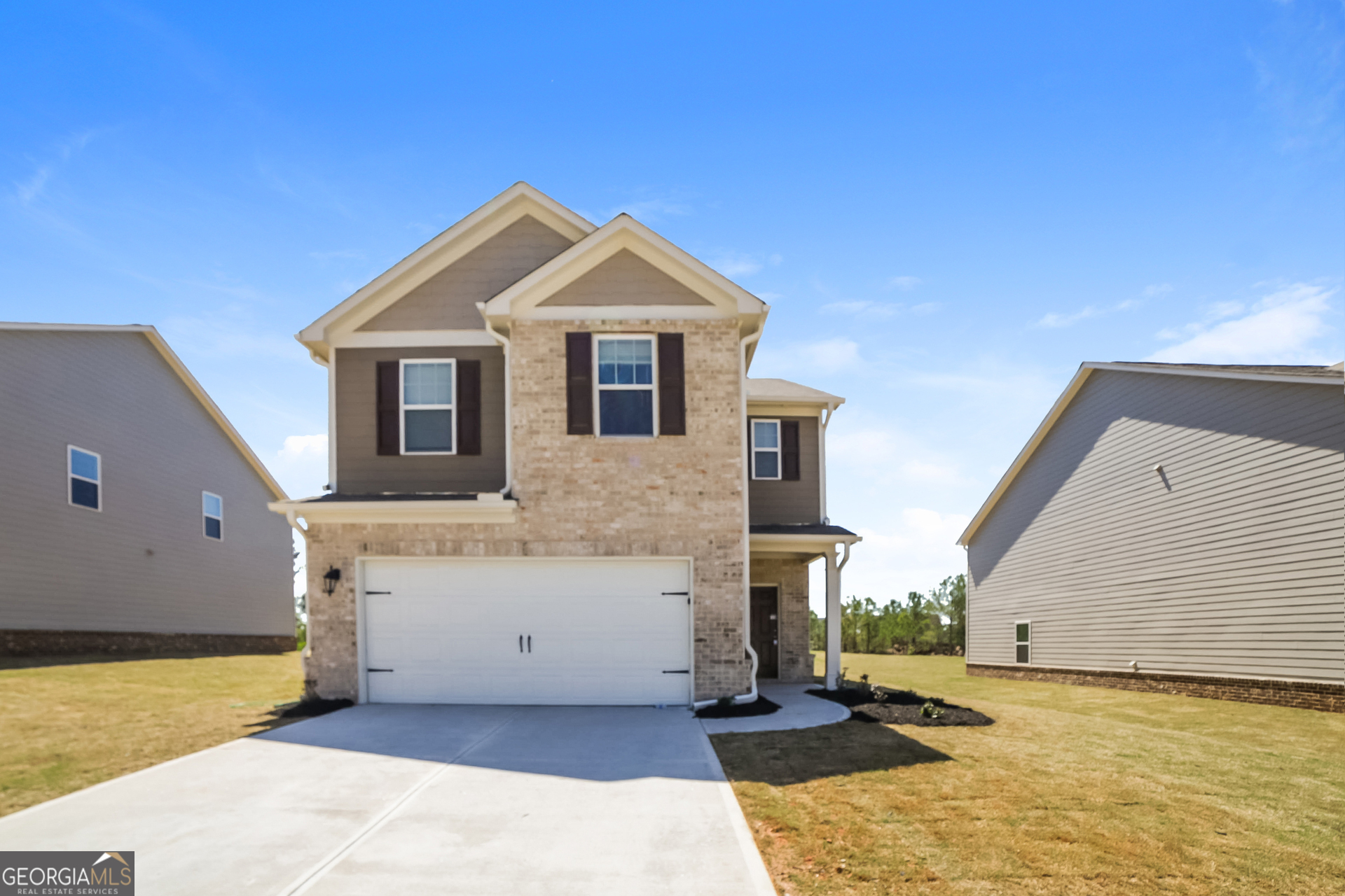 a front view of a house with a yard