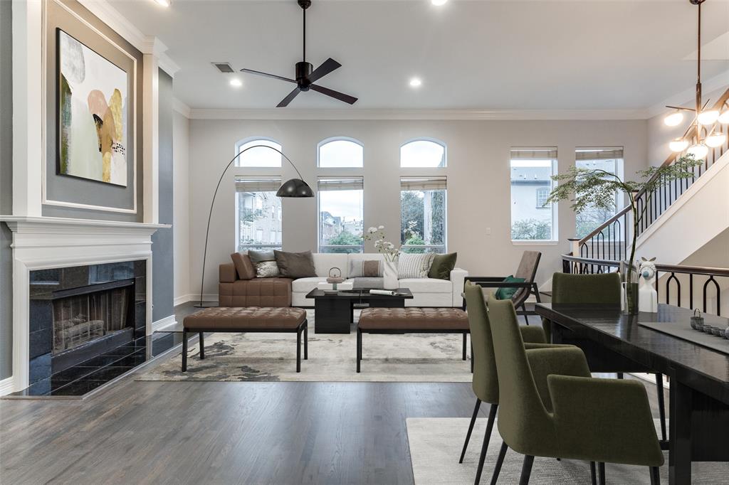 a living room with furniture a fireplace and a large window