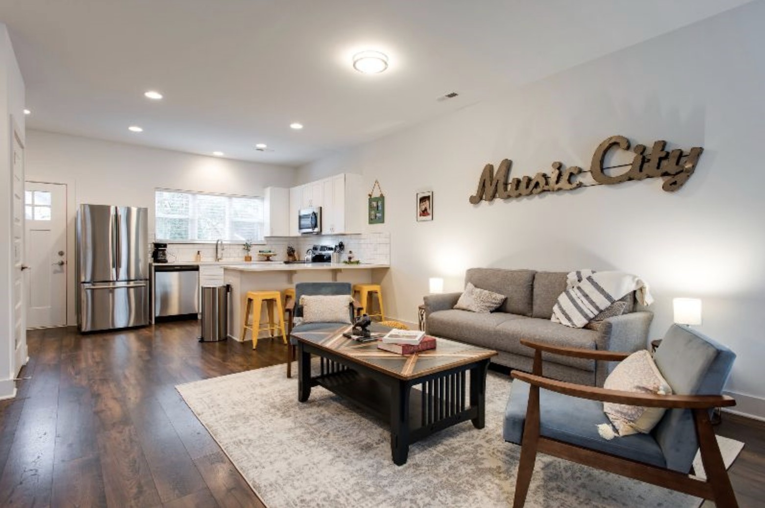 a living room with furniture and kitchen view