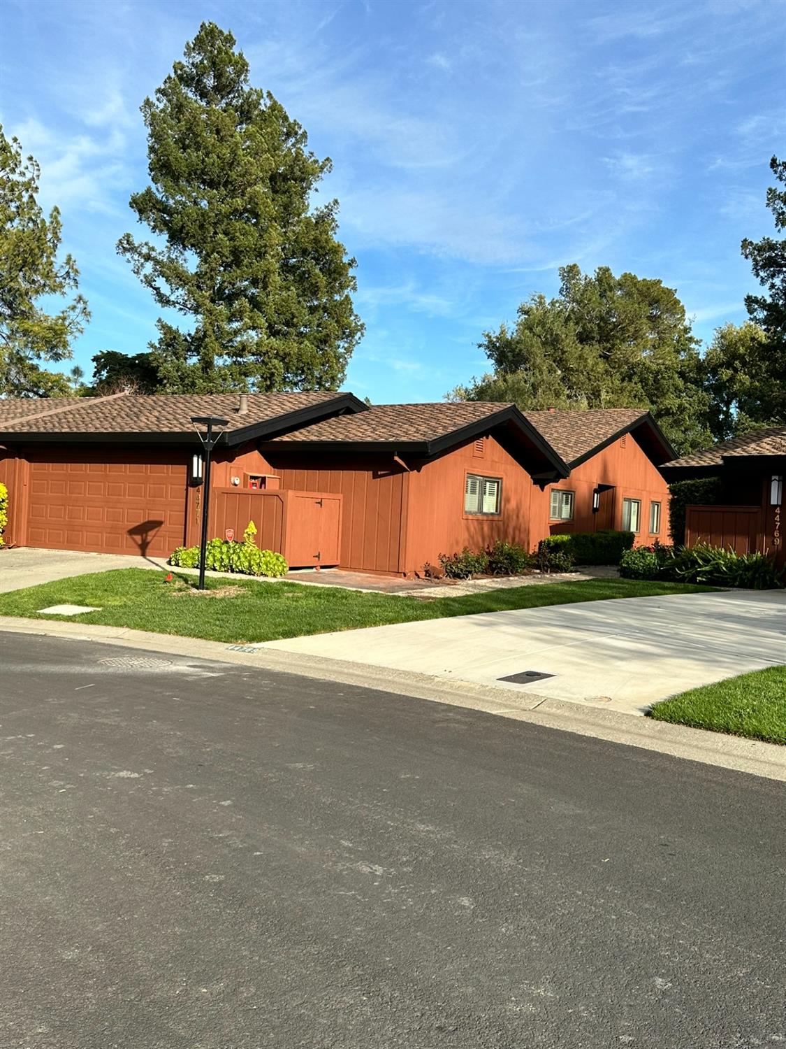 a view of an house with backyard space and parking