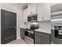 a kitchen with appliances a sink and cabinets