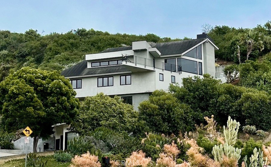 a view of a house with a yard and sitting area