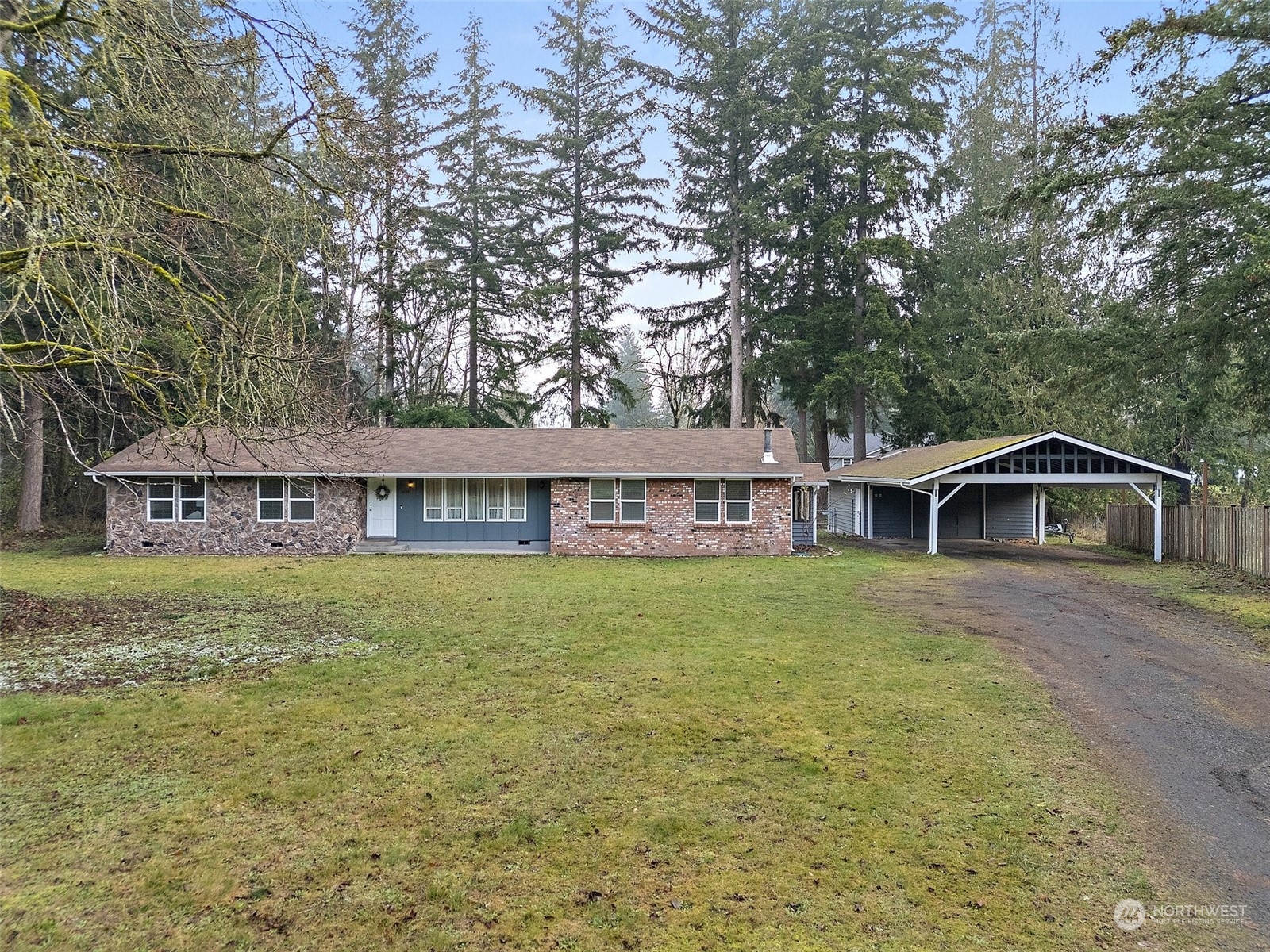 a view of a big house with a big yard and large trees