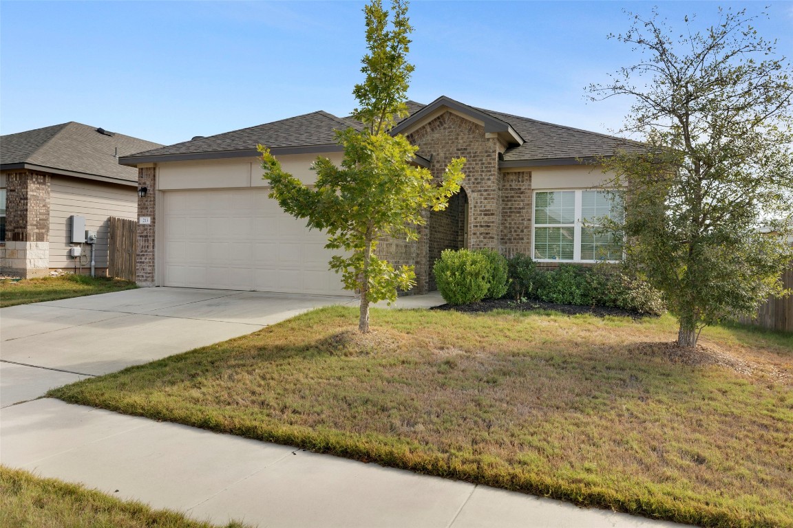 a front view of a house with garden