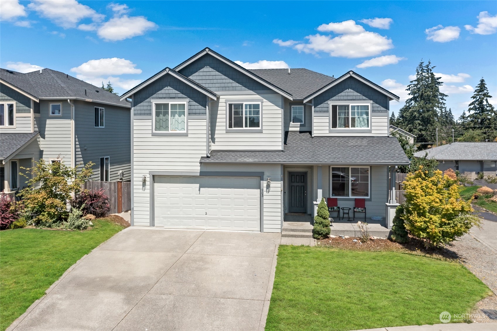 a front view of a house with a yard and garage